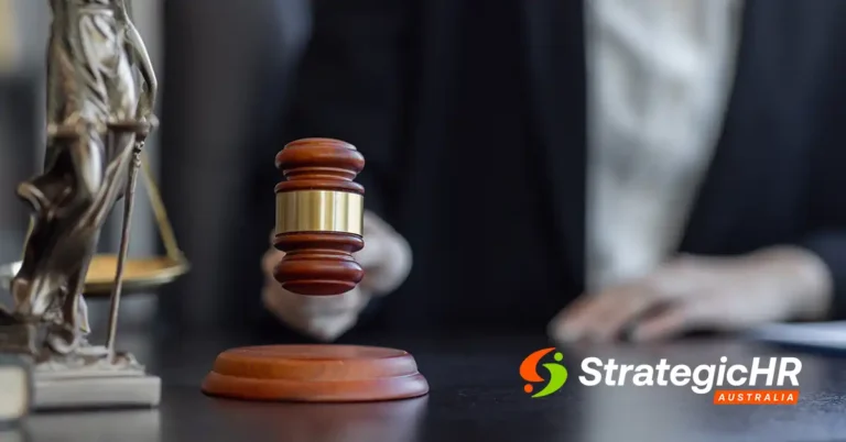 A person in a suit holds a wooden gavel above a sound block, with the scales of justice nearby and the Strategic HR Australia logo in the bottom right corner.